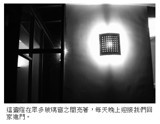 這盞燈在眾多玻璃窗之間亮著，每天晚上迎接我們回家進門。